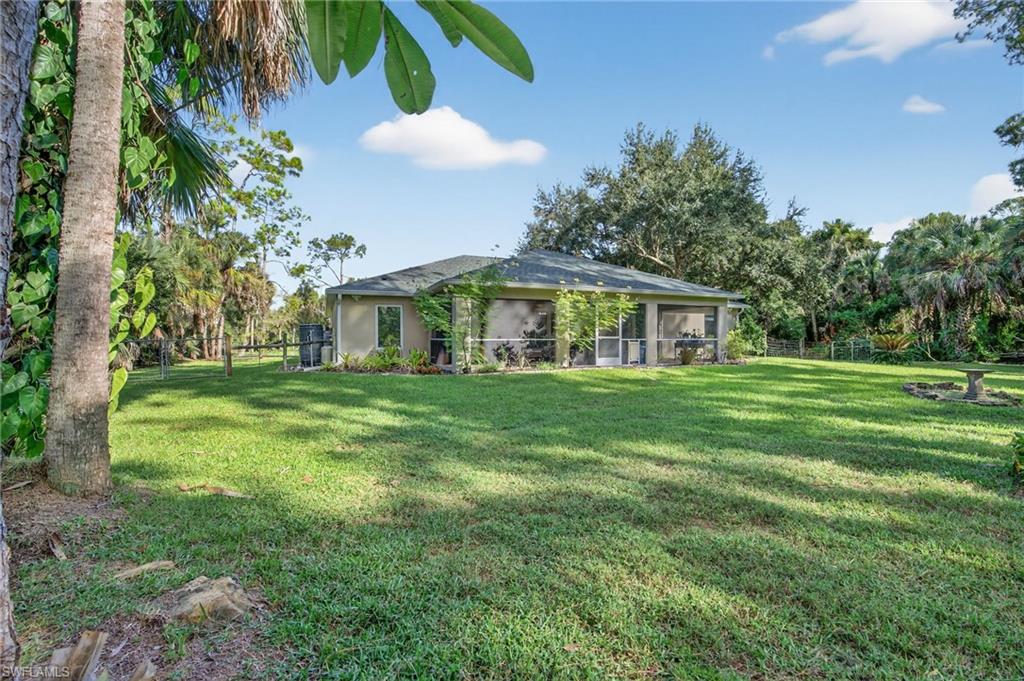 1741 17th Street Southwest Naples, FL 34117 - Photo 43 of 50 Fenced backyard with a sunroom