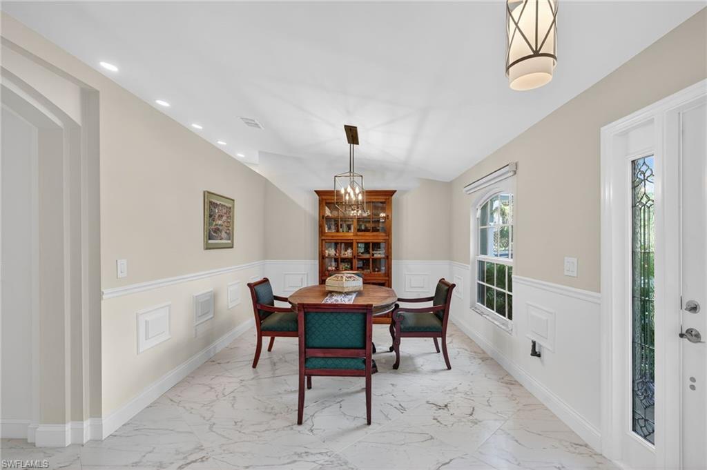 1741 17th Street Southwest Naples, FL 34117 - Photo 8 of 50 Dining room with light satin finish porcelain tile flooring, a wainscoted wall, a decorative wall, and recessed lighting
