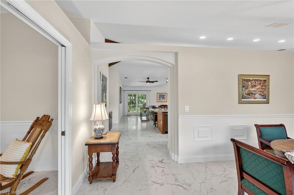 1741 17th Street Southwest Naples, FL 34117 - Photo 10 of 50 Hallway featuring light satin finish porcelain tile flooring, recessed lighting, and arched walkways