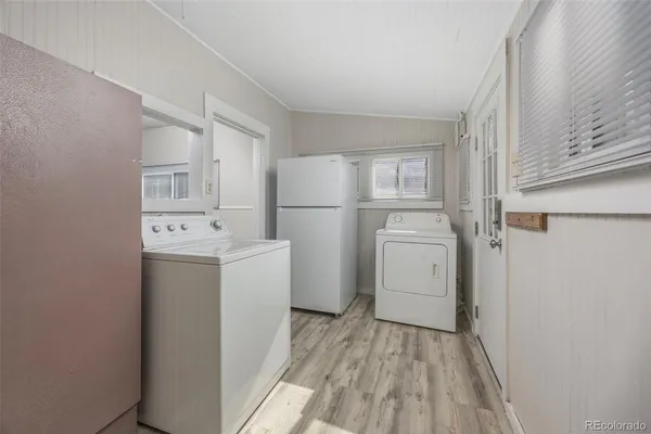 a utility room with cabinets washer and dryer