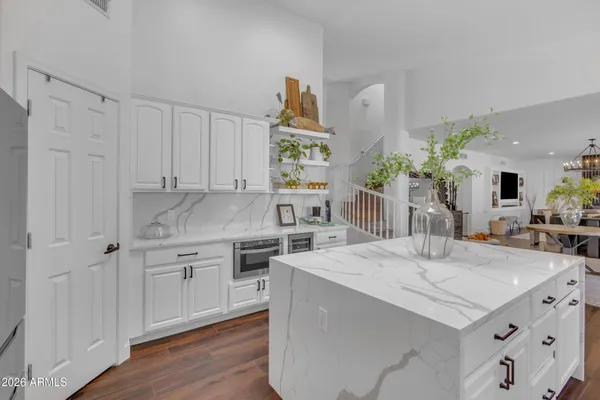 a kitchen with a sink cabinets and wooden floor