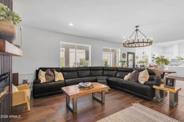 a living room with furniture a rug and a chandelier