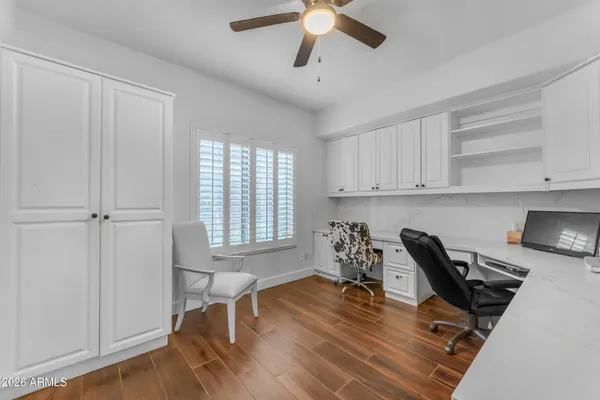 a workspace with wooden floor and a window