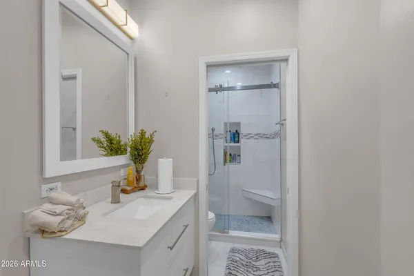 a bathroom with a sink a toilet and vanity