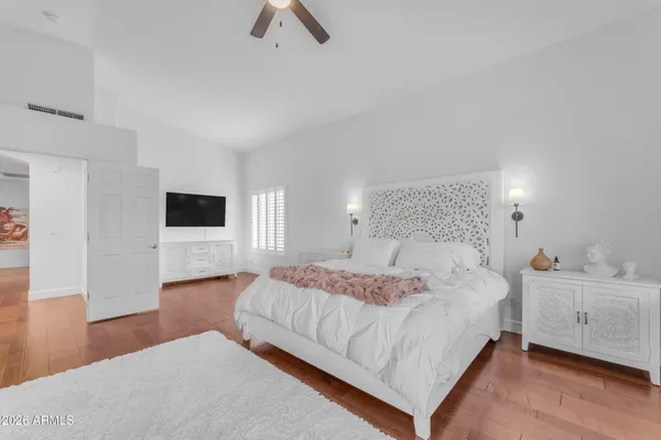 a bedroom with a bed and a flat screen tv
