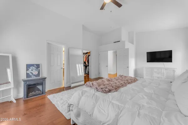 a bedroom with a bed and a television