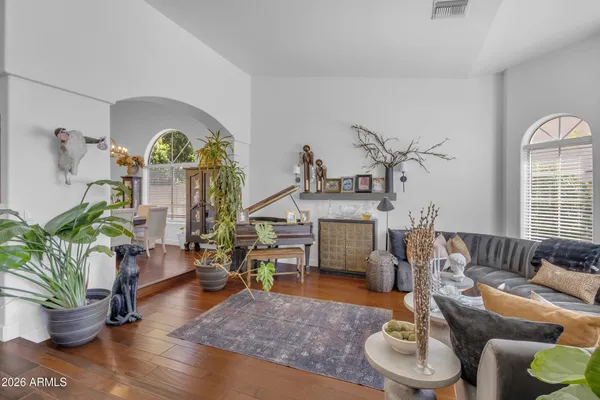 a living room with furniture a chandelier and a window