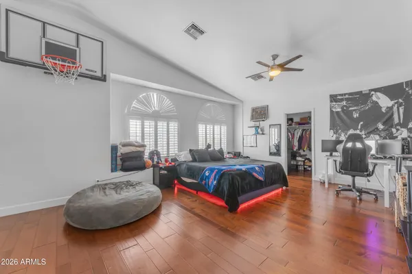 a bedroom with a bed and wooden floor