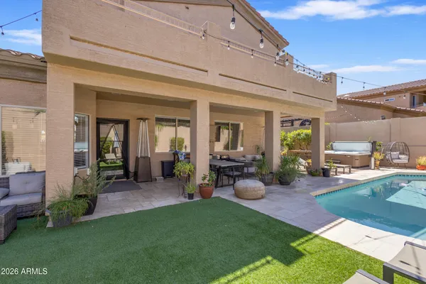 a view of a house with backyard porch and sitting area