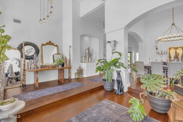 a living room with furniture potted plant and a chandelier