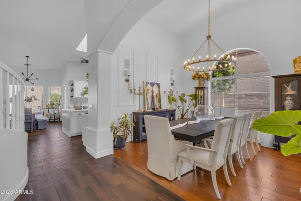 a view of a dining room with furniture wooden floor and a chandelier