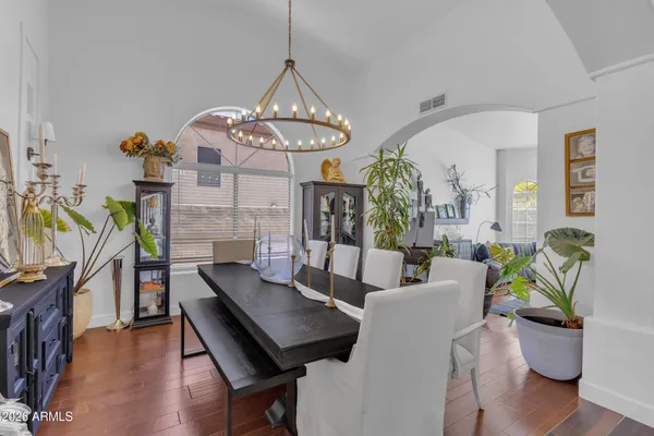 a view of a dining room with furniture and chandelier
