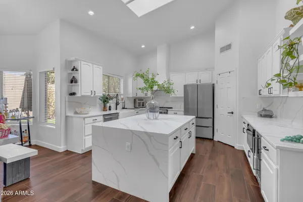 a kitchen with stainless steel appliances a sink stove and refrigerator