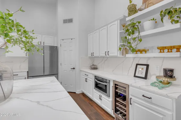 a kitchen with stainless steel appliances a white cabinets and a counter top space