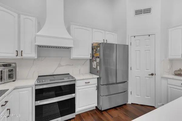 a kitchen with stainless steel appliances a refrigerator stove and cabinets