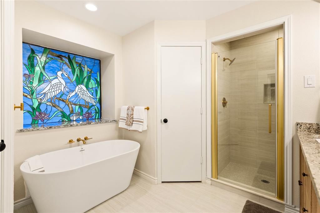 2850 Oak Tree Lane Midlothian, TX 76065 - Photo 18 of 40 a white bath tub sitting next to a bathroom