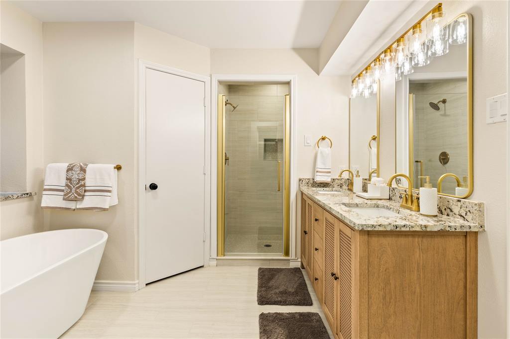 2850 Oak Tree Lane Midlothian, TX 76065 - Photo 19 of 40 a bathroom with a granite countertop sink a mirror and a bathtub