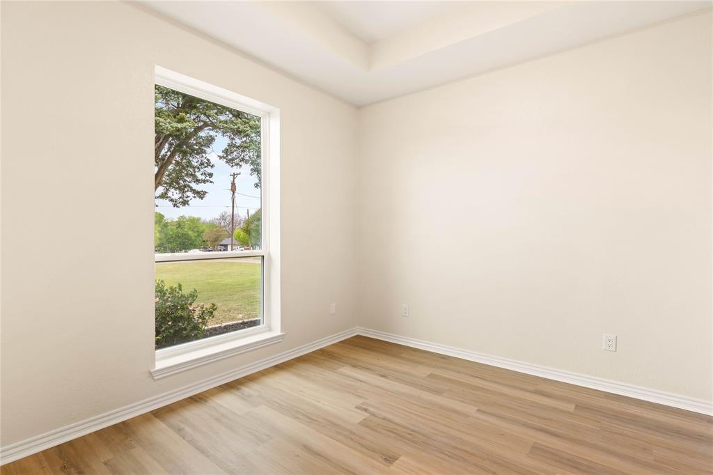 2850 Oak Tree Lane Midlothian, TX 76065 - Photo 25 of 40 an empty room with wooden floor and a window