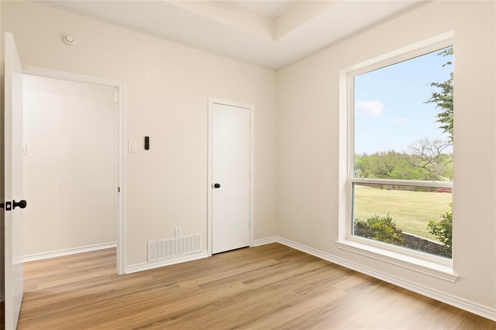 2850 Oak Tree Lane Midlothian, TX 76065 - Photo 26 of 40 a view of an empty room with wooden floor and a window
