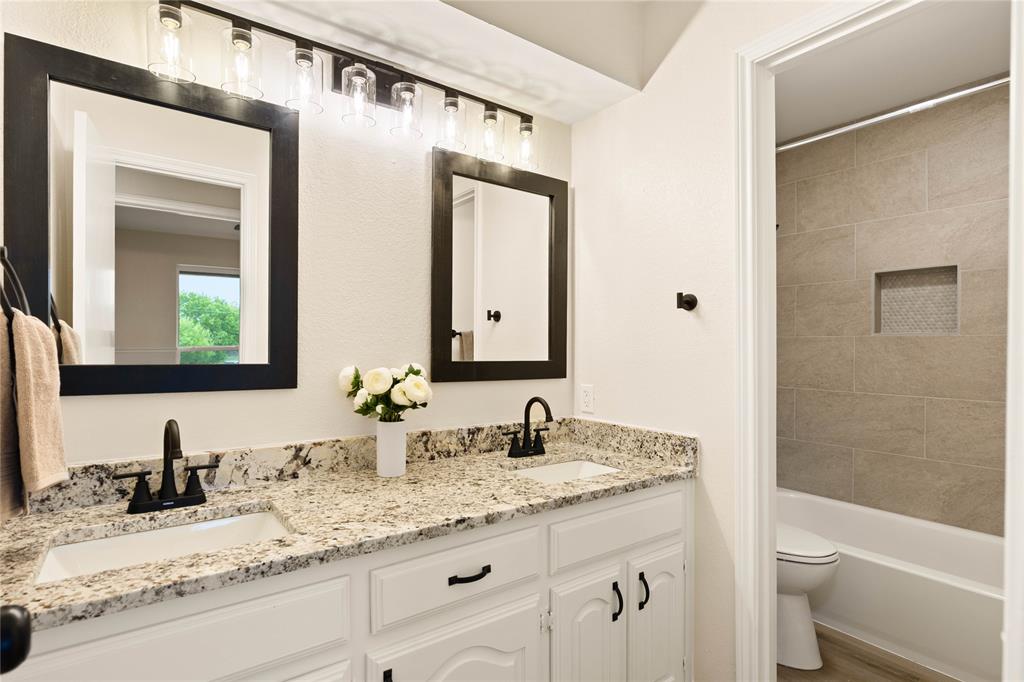 2850 Oak Tree Lane Midlothian, TX 76065 - Photo 27 of 40 a bathroom with a granite countertop sink toilet and shower
