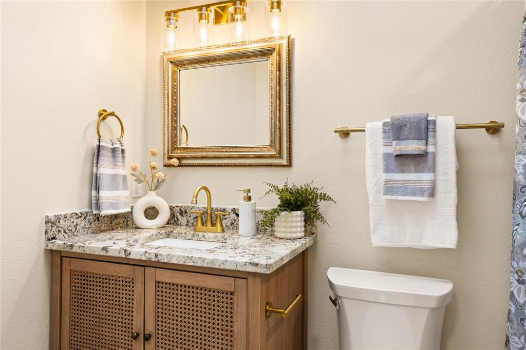 2850 Oak Tree Lane Midlothian, TX 76065 - Photo 28 of 40 a bathroom with a granite countertop toilet sink and mirror