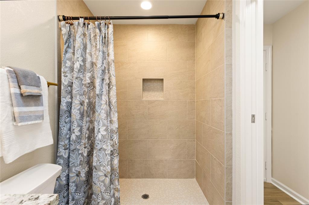 2850 Oak Tree Lane Midlothian, TX 76065 - Photo 29 of 40 a bathroom with a shower and a toilet