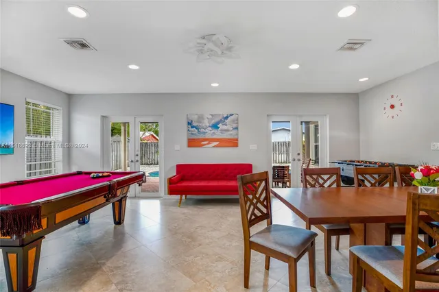 a living room with furniture and pool table