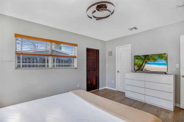 a bedroom with a bed and a dresser