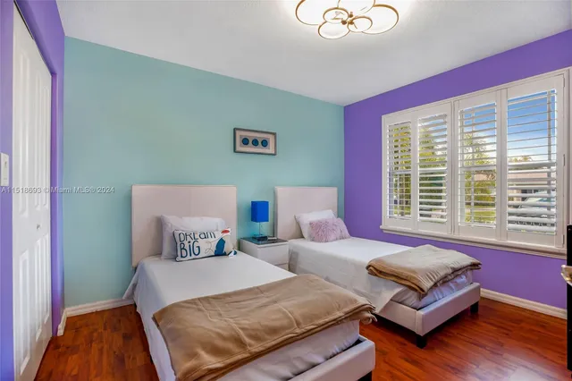 a bedroom with furniture and a large window