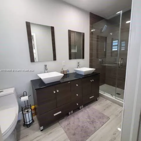 a bathroom with a double vanity sink and a mirror