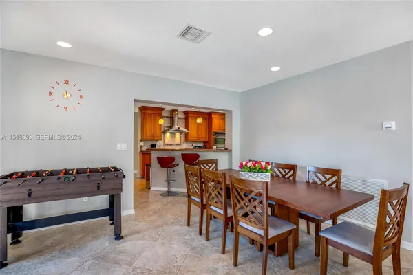 a dining room with furniture and a potted plant