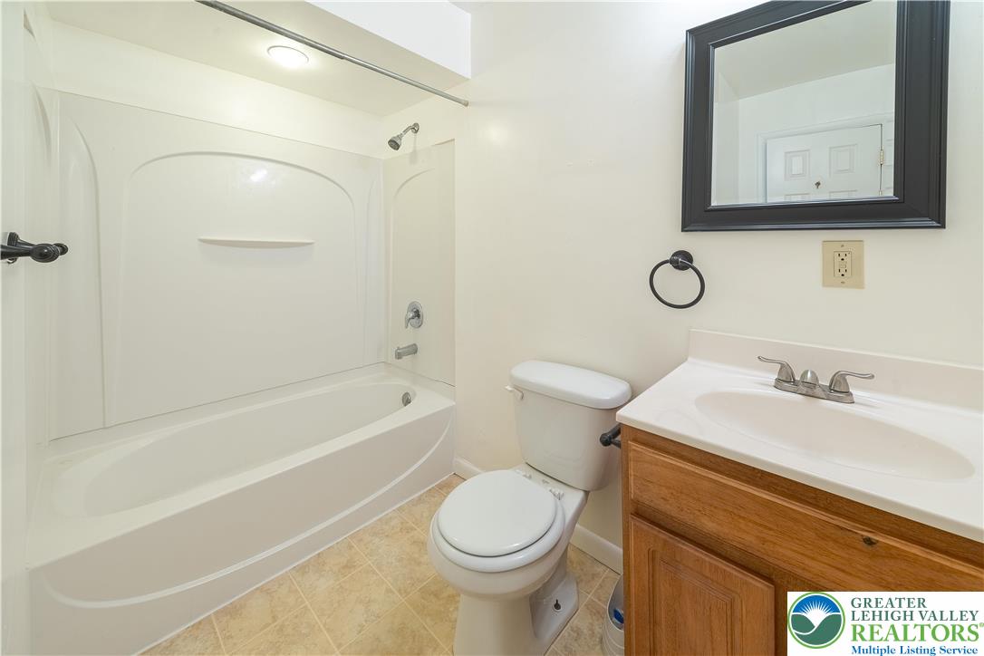 7528 Buttercup Road Lower Macungie Township, PA 18062 - Photo 22 of 30 a bathroom with a granite countertop toilet sink and mirror