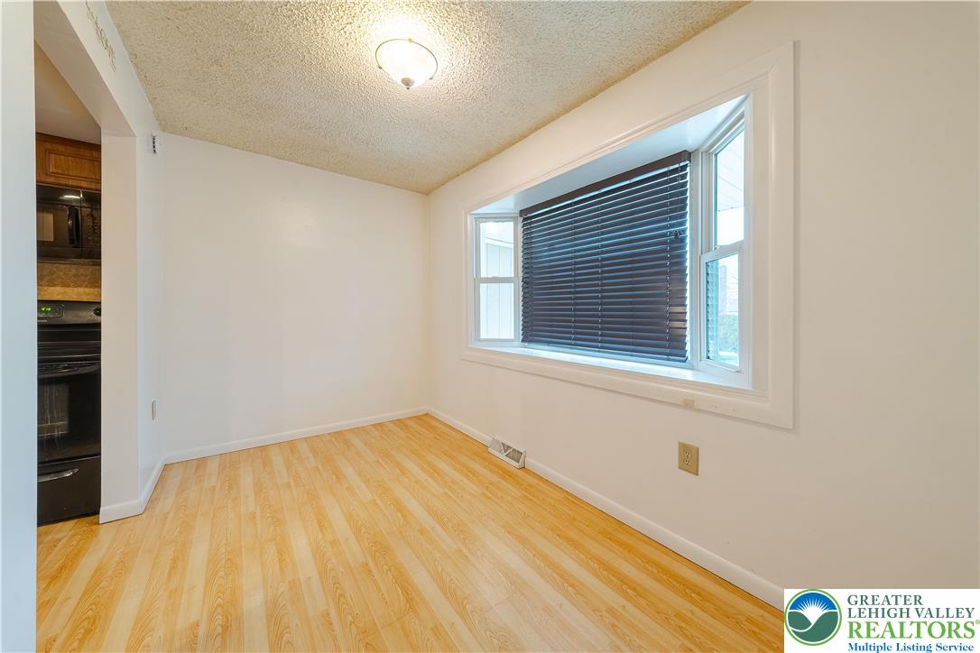 7528 Buttercup Road Lower Macungie Township, PA 18062 - Photo 6 of 30 a view of a room that has a window and wooden floor