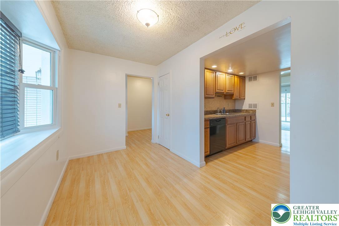 7528 Buttercup Road Lower Macungie Township, PA 18062 - Photo 7 of 30 a view of kitchen and empty room with wooden floor