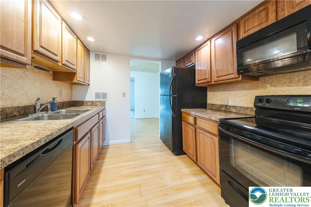 7528 Buttercup Road Lower Macungie Township, PA 18062 - Photo 9 of 30 a kitchen with stainless steel appliances granite countertop a stove and a sink