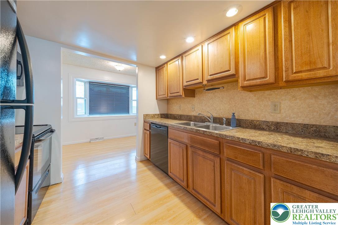 7528 Buttercup Road Lower Macungie Township, PA 18062 - Photo 10 of 30 a kitchen with stainless steel appliances granite countertop a stove a sink and a refrigerator