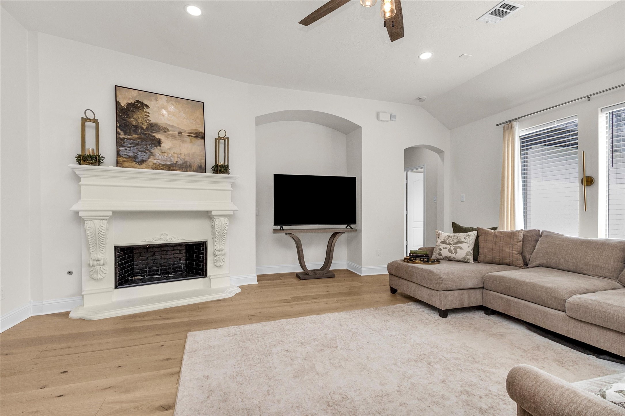 10004 Summer Ridge Lane Conroe, TX 77302 - Photo 22 of 50 a living room with furniture a fireplace and a flat screen tv