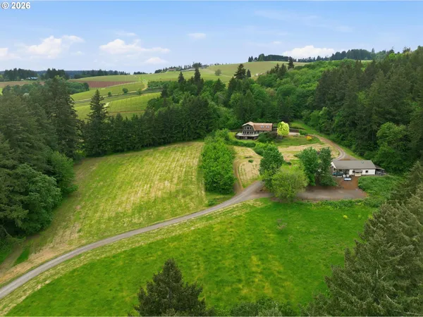 a view of a green field with an ocean view