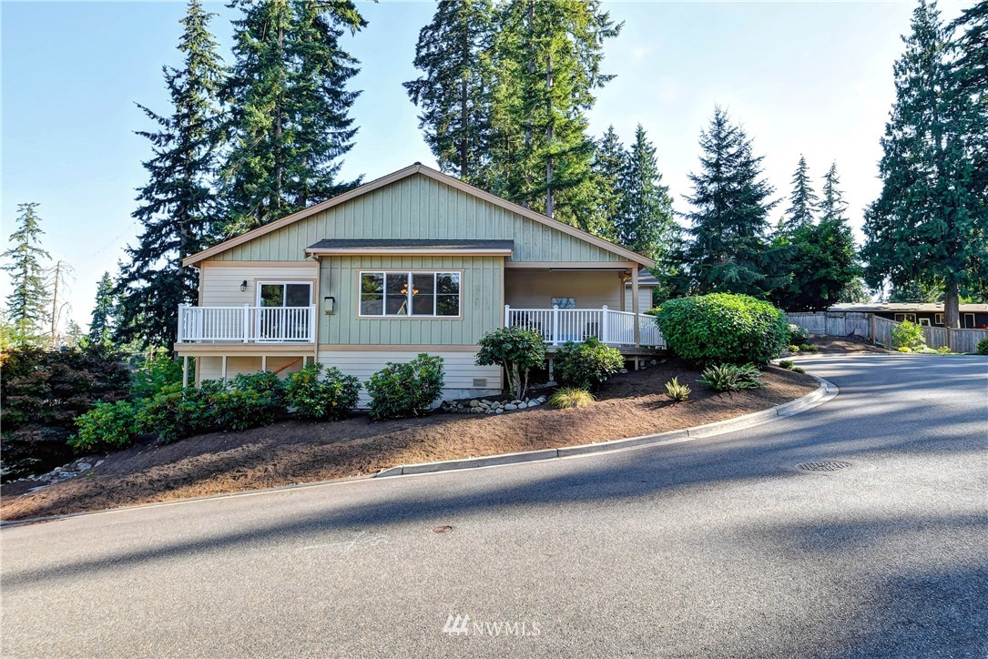 214 159th Street Southeast Bothell, WA 98012 - Photo 1 of 26 a front view of a house with a yard and potted plants