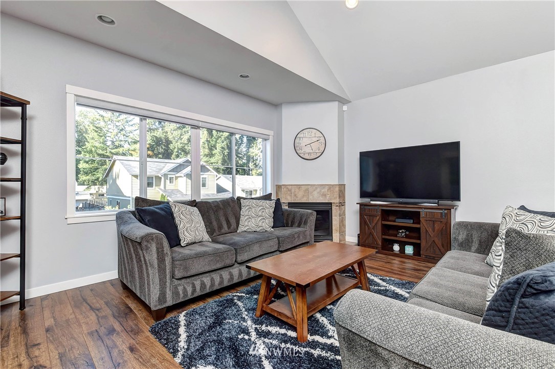 214 159th Street Southeast Bothell, WA 98012 - Photo 9 of 26 a living room with furniture a flat screen tv and a large window