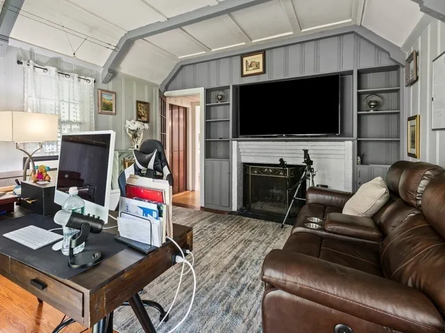 a large bedroom with a bed and wooden floor