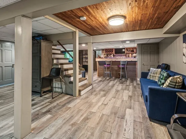 a room with stainless steel appliances kitchen island granite countertop a sink and cabinets
