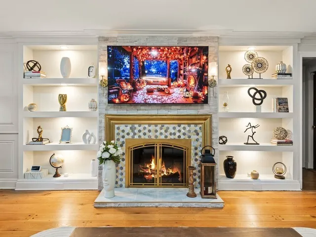 a living room with fireplace furniture and a flat screen tv