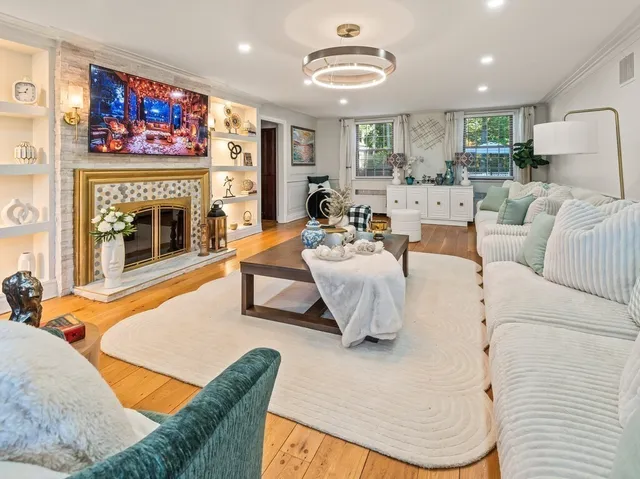 a living room with furniture and a fireplace