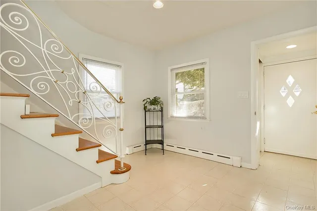 a view of entryway and hall with a front door