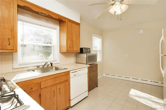 a kitchen with a sink cabinets and window