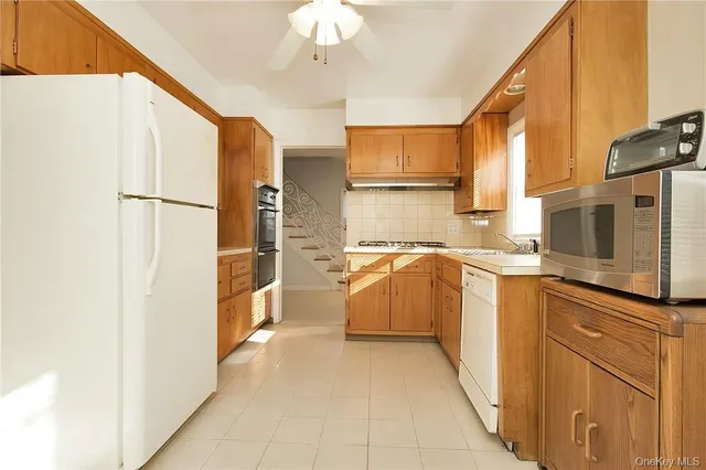 a view of a kitchen with a sink and a refrigerator