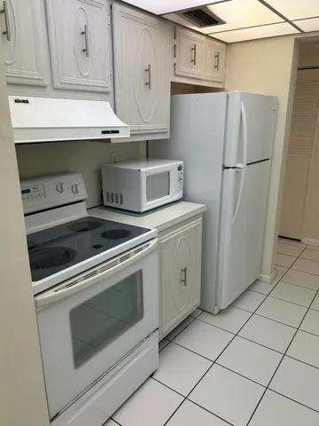 a kitchen with appliances and cabinets