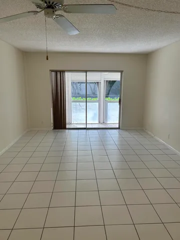 a view of a livingroom with an empty space and a window