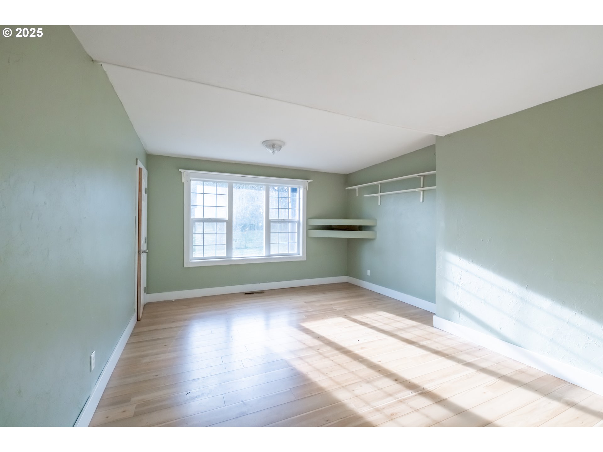 96470 Highway 99 Junction City, OR 97448 - Photo 13 of 48 a view of an empty room with wooden floor and a window